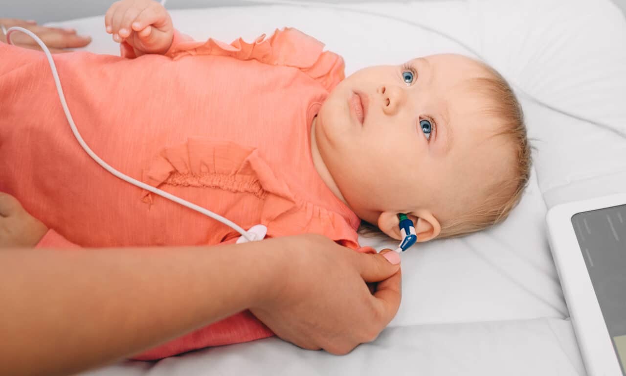 Baby girl having her hearing tested.