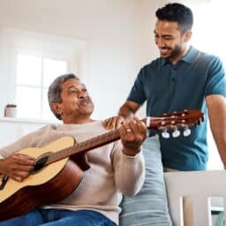 Father and son playing guitar and singing